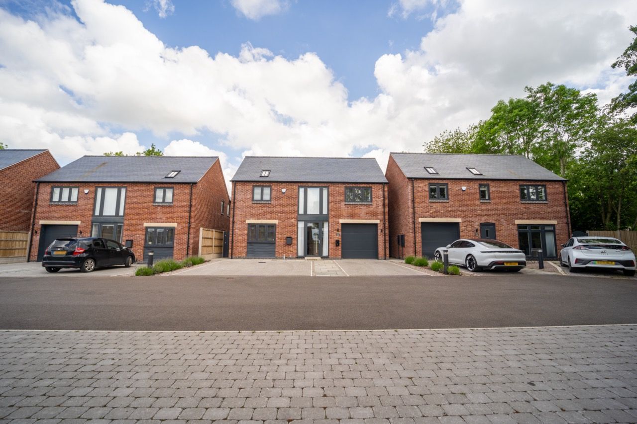Newbold, a row of houses with cars parked in front of them.