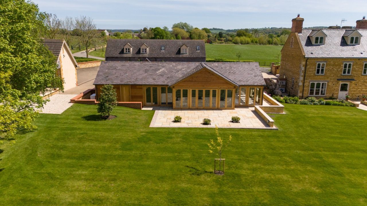 St Dennis Pool House, An aerial view of a large house with a large lawn in front of it.