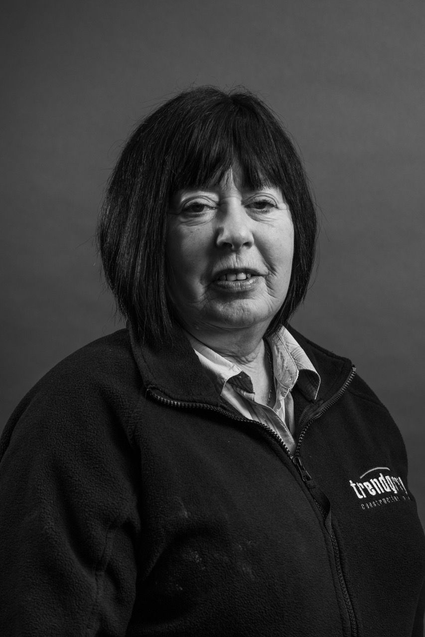 A black and white photo of a woman wearing a black jacket.