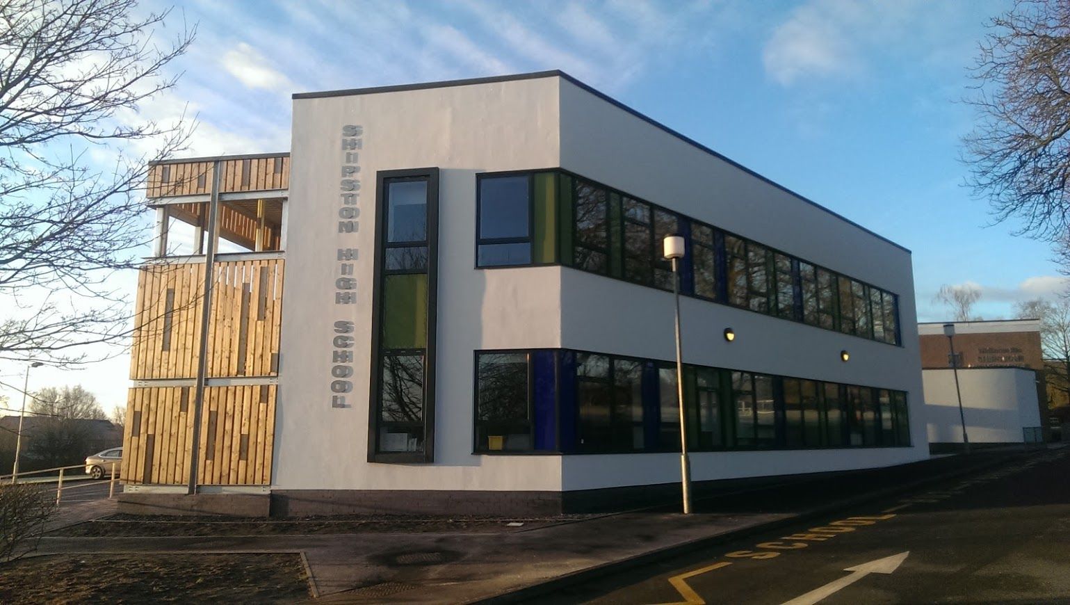 Shipstone High School, a large white building with a sign on the side that says ' ambulance '