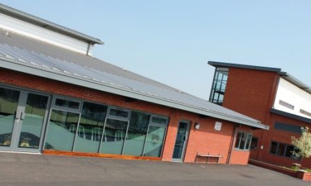 Stratford High School, a large building with a lot of windows and a solar panel on the roof.