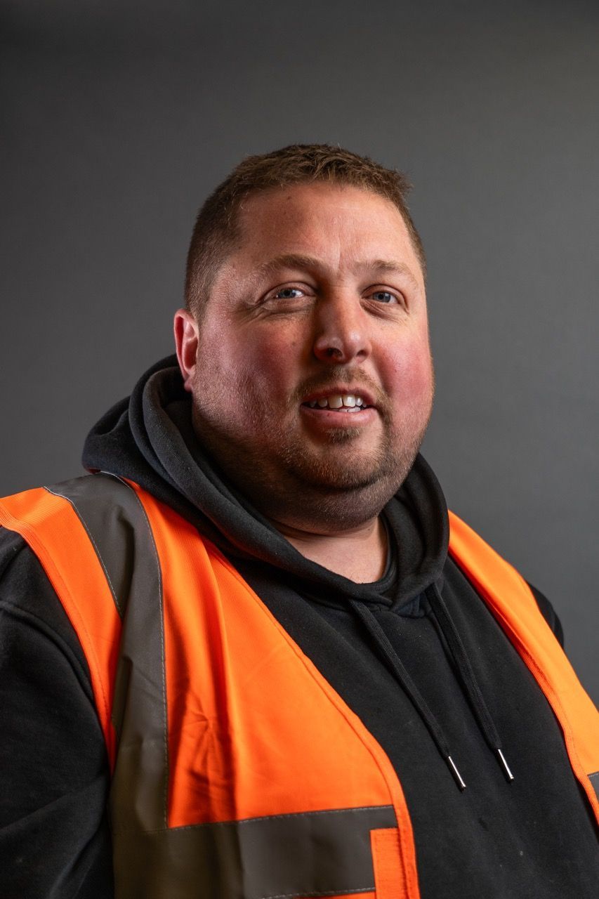 David Clarke, a man wearing an orange safety vest and a black hoodie.