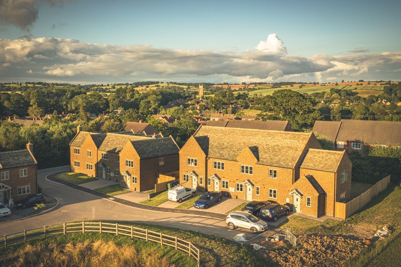 Warmington Fields, an aerial view of a residential area with houses and cars parked in front of them.
