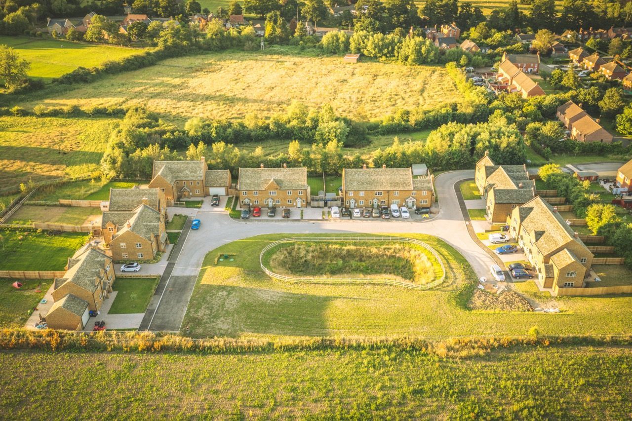 Brailes, An aerial view of a residential area with houses and fields.