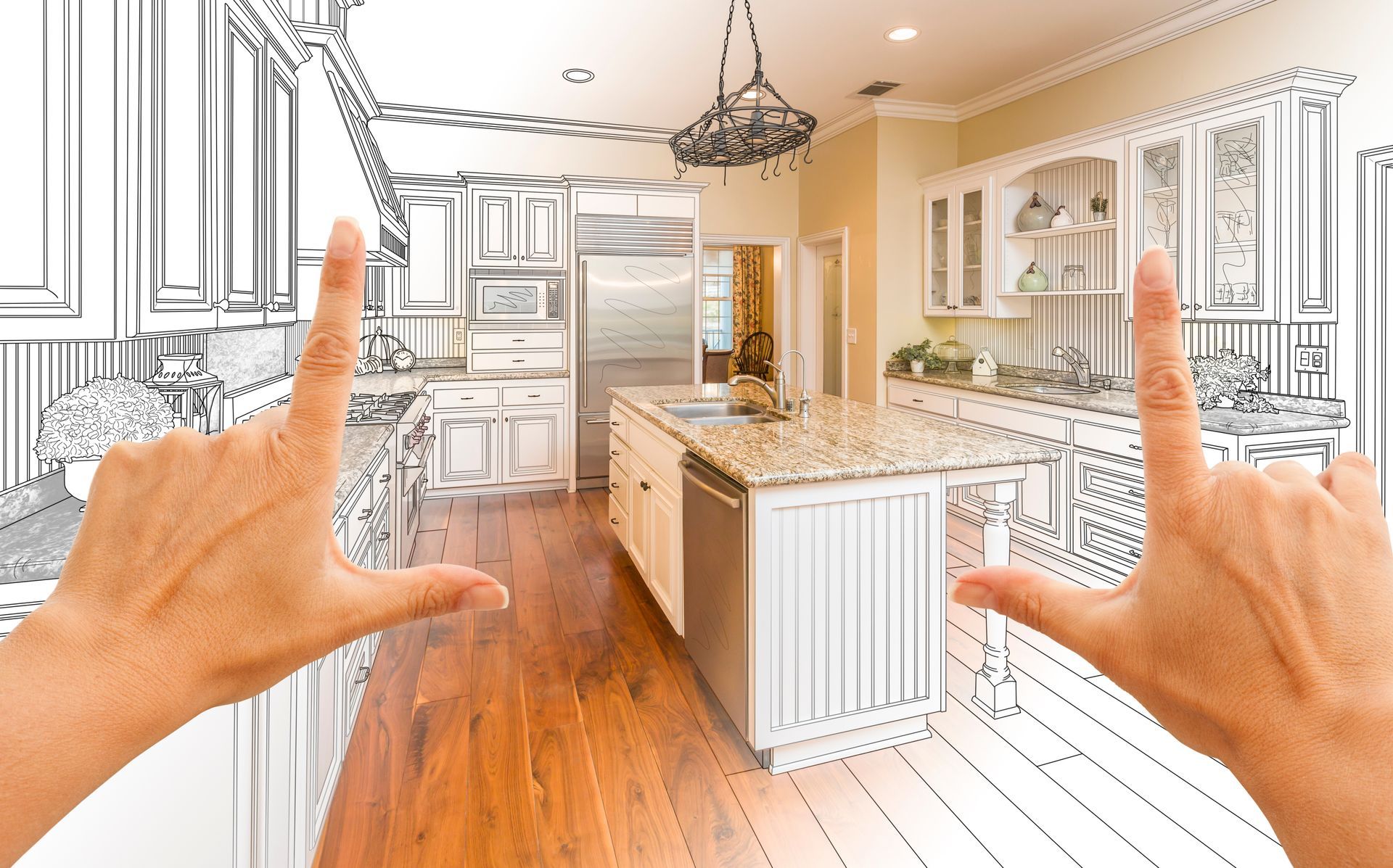 Hands framing design showcasing kitchen renovations drawing and finished custom kitchen concept.