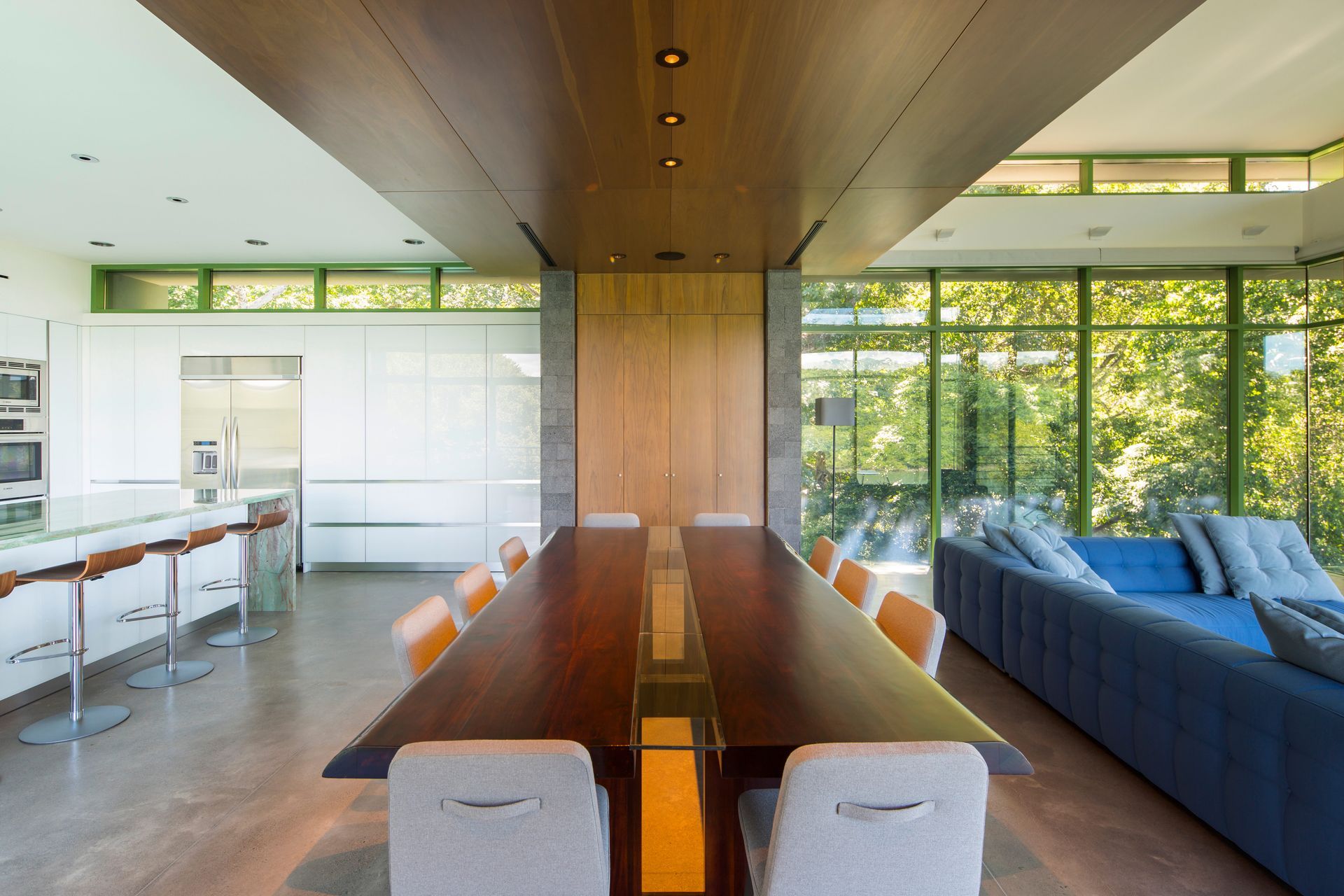A living room with a long table and chairs