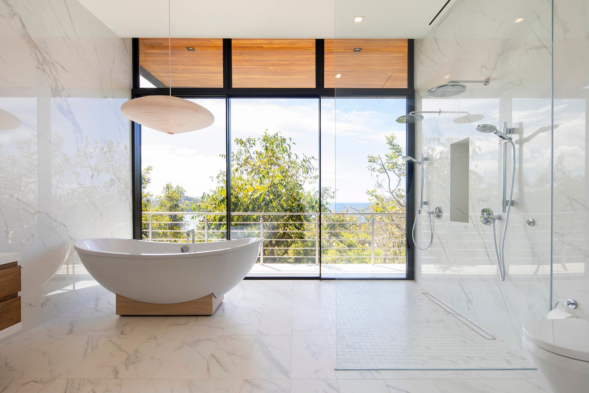 A luxury bathroom with a bathtub looking at the costa rica ocean