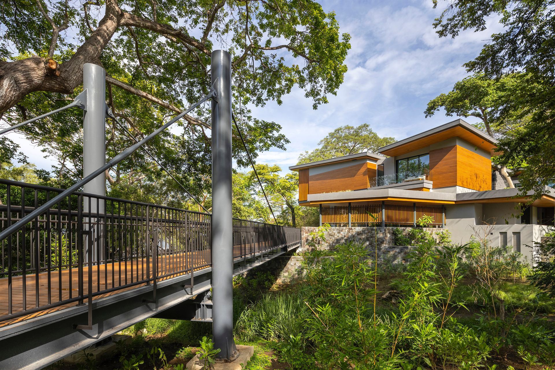 a bridge leading to a house in the woods