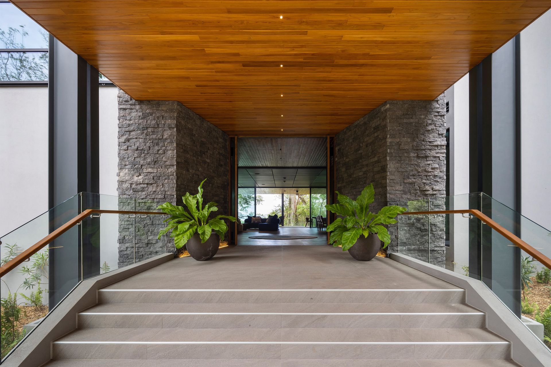 a set of stairs leading up to a building with a wooden ceiling