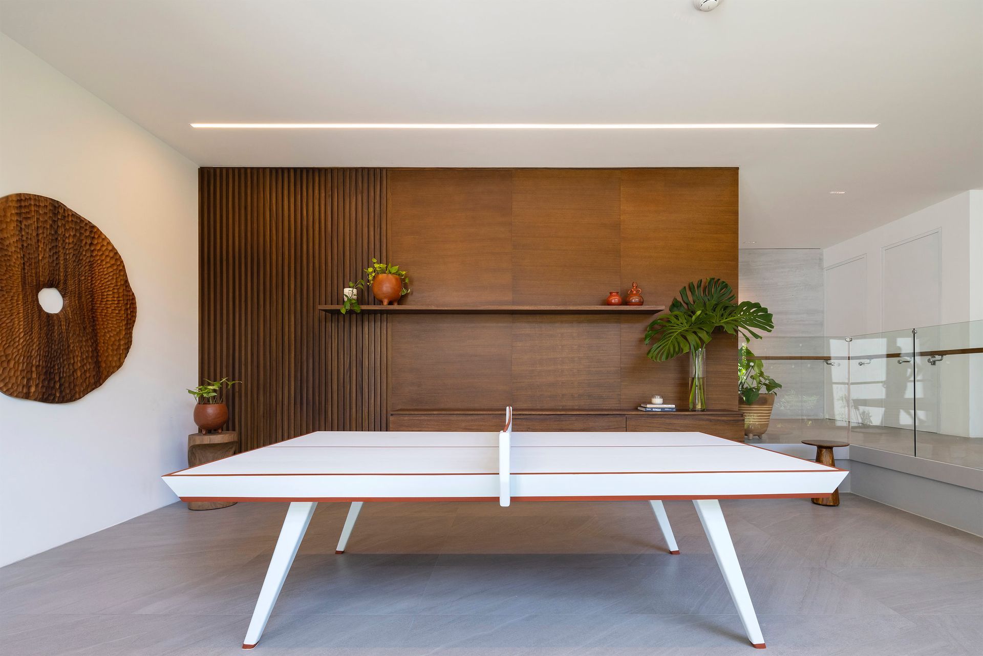 there is a ping pong table in the middle of the room .