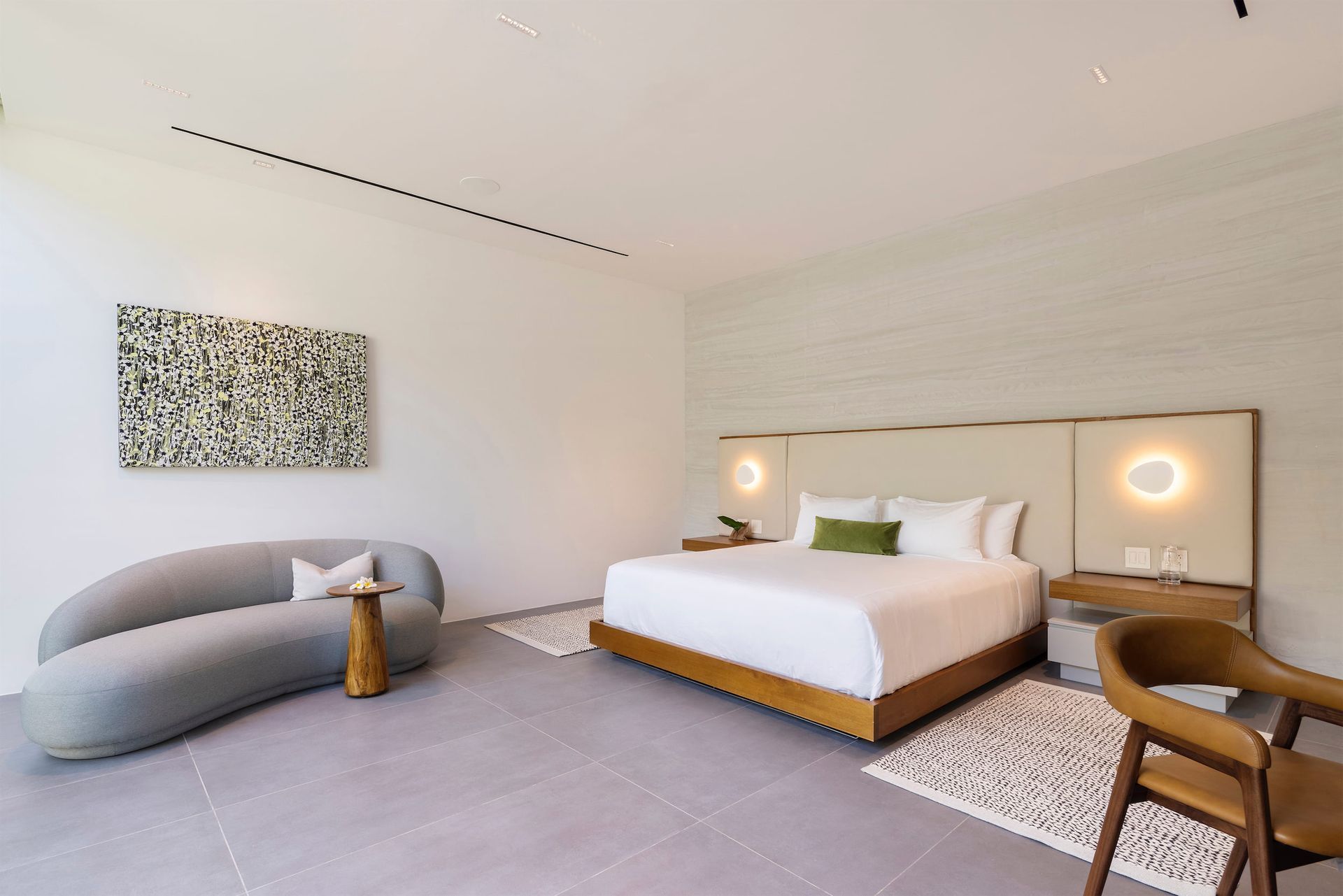 a bedroom with a large bed and a couch .