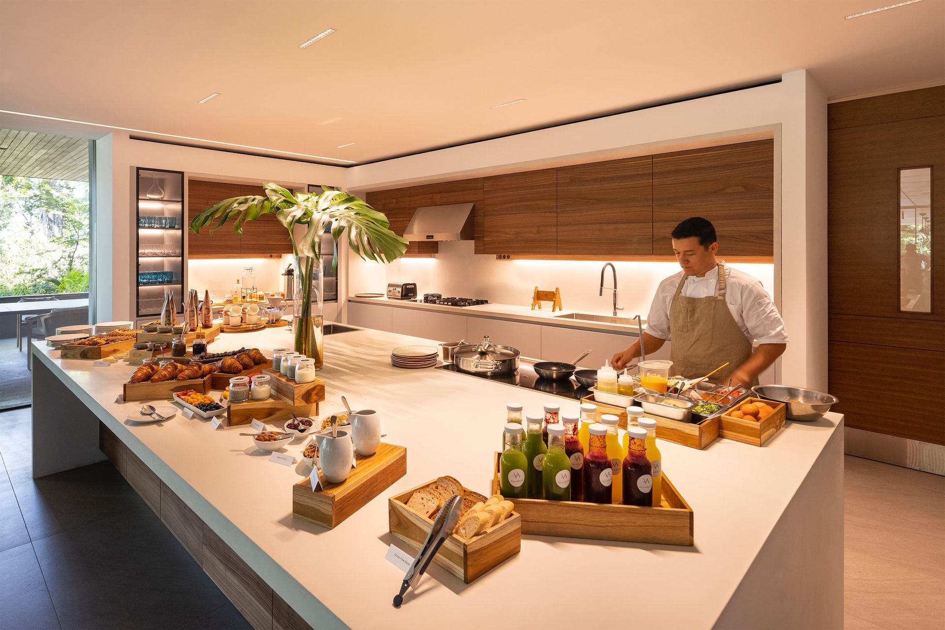 a man in an apron is preparing food in a kitchen .