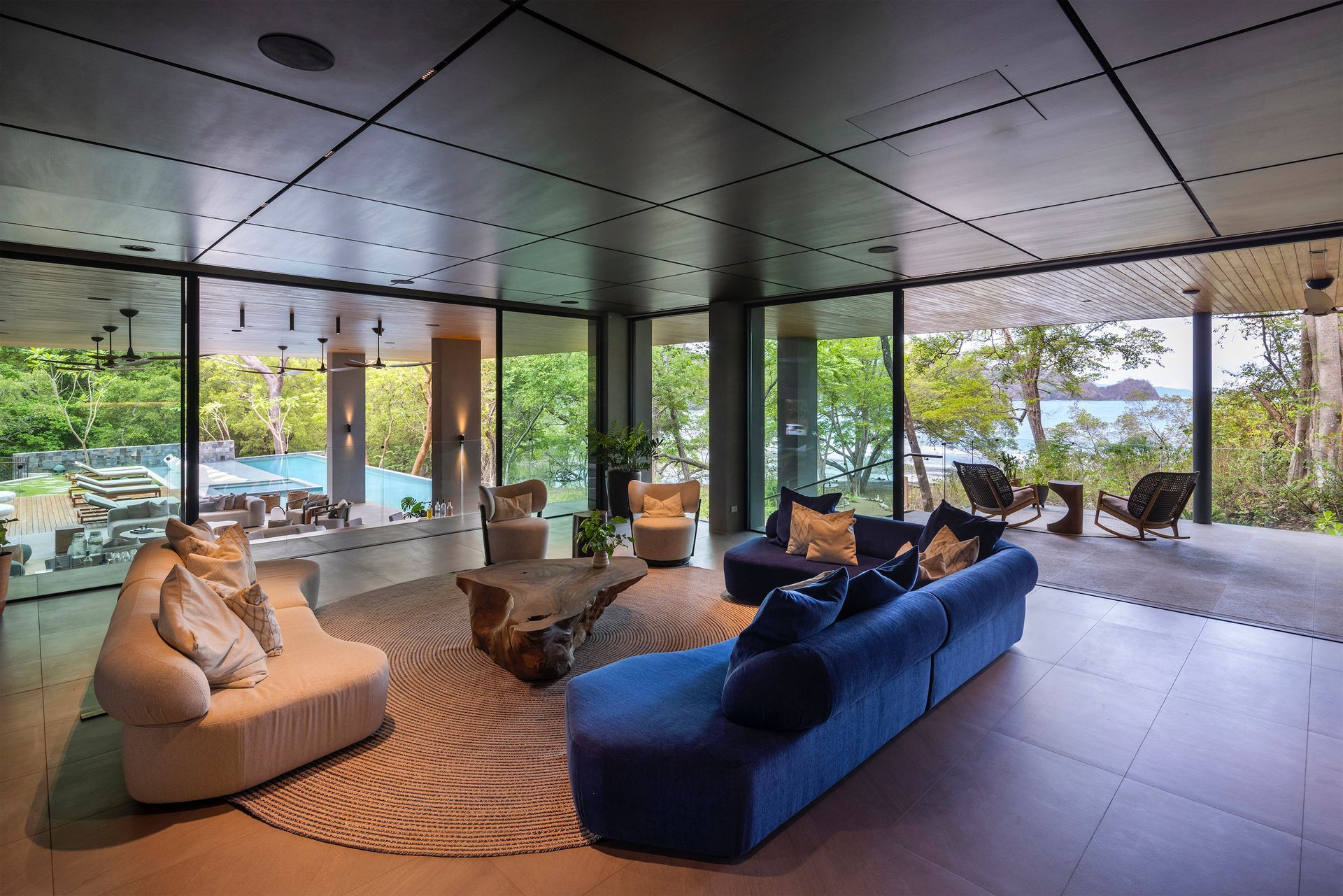 a living room with a blue couch and a white couch