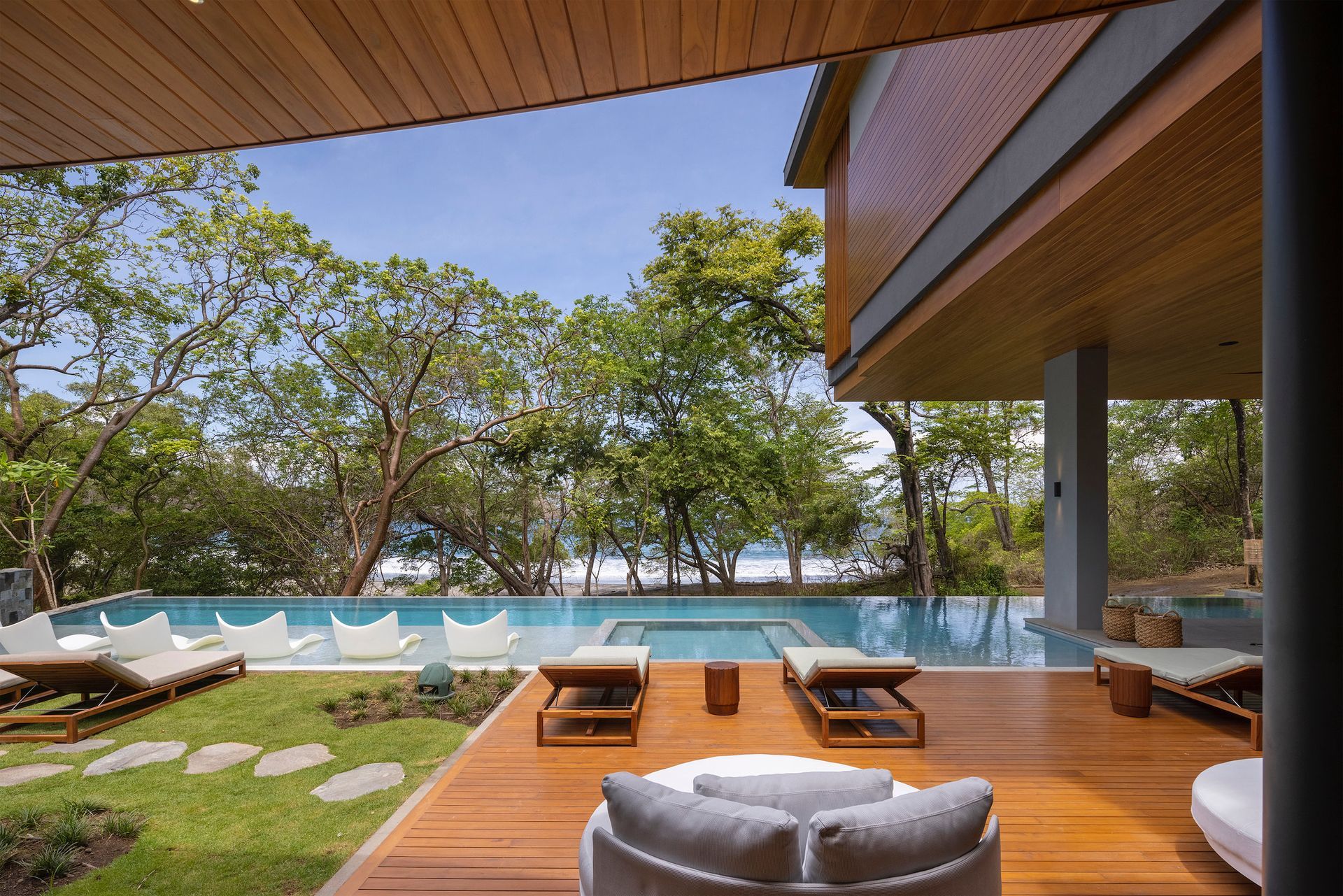 a large house with a swimming pool and a wooden deck