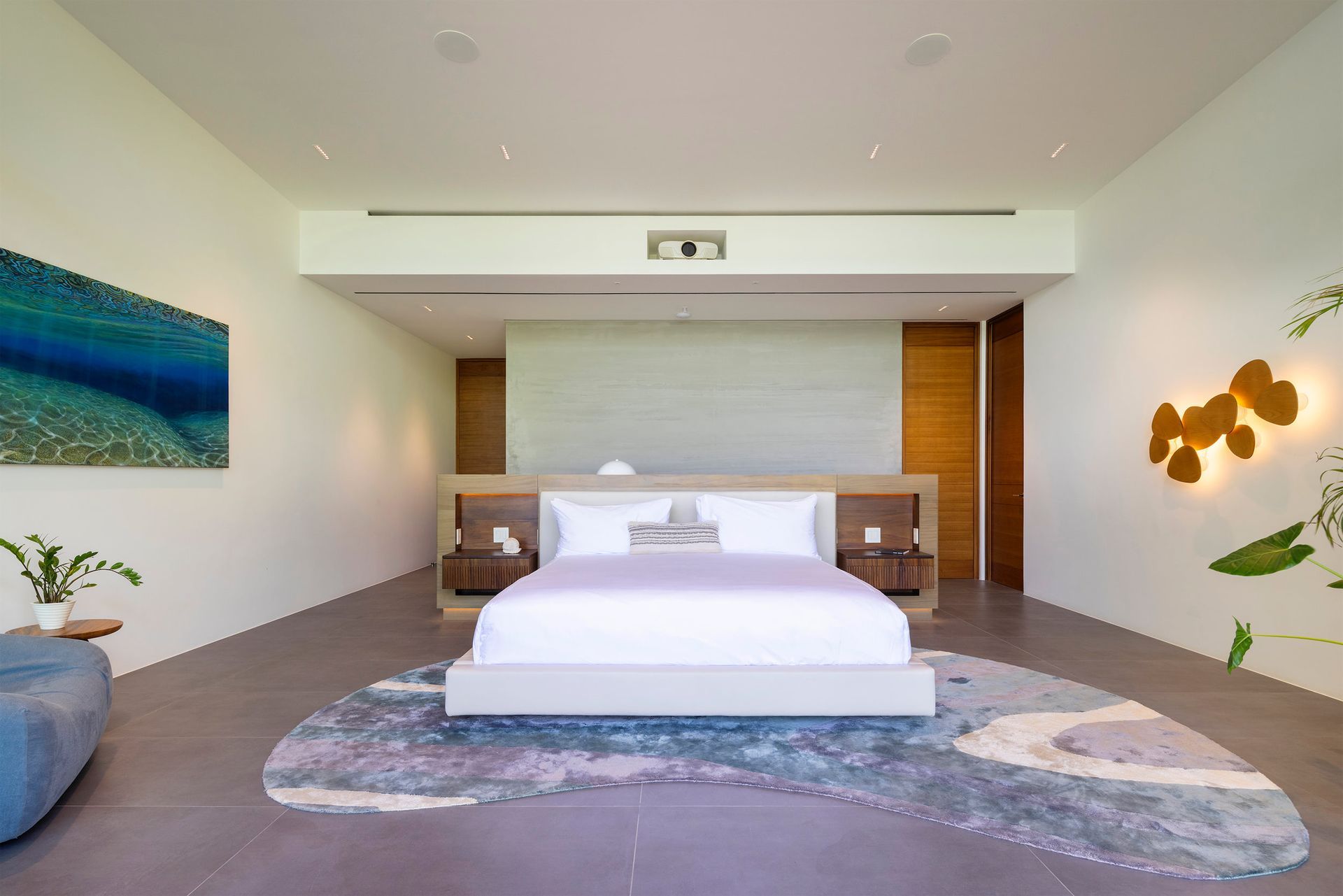 there is a large bed in the middle of the room .