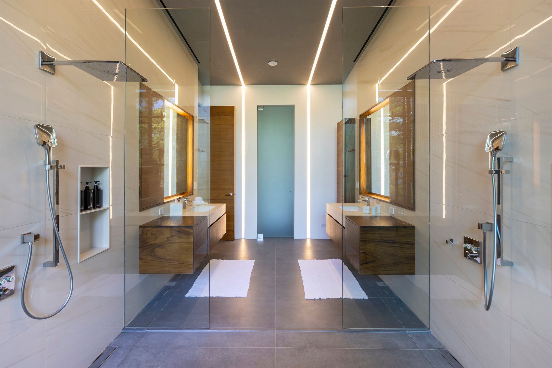 a bathroom with two sinks and a walk in shower .