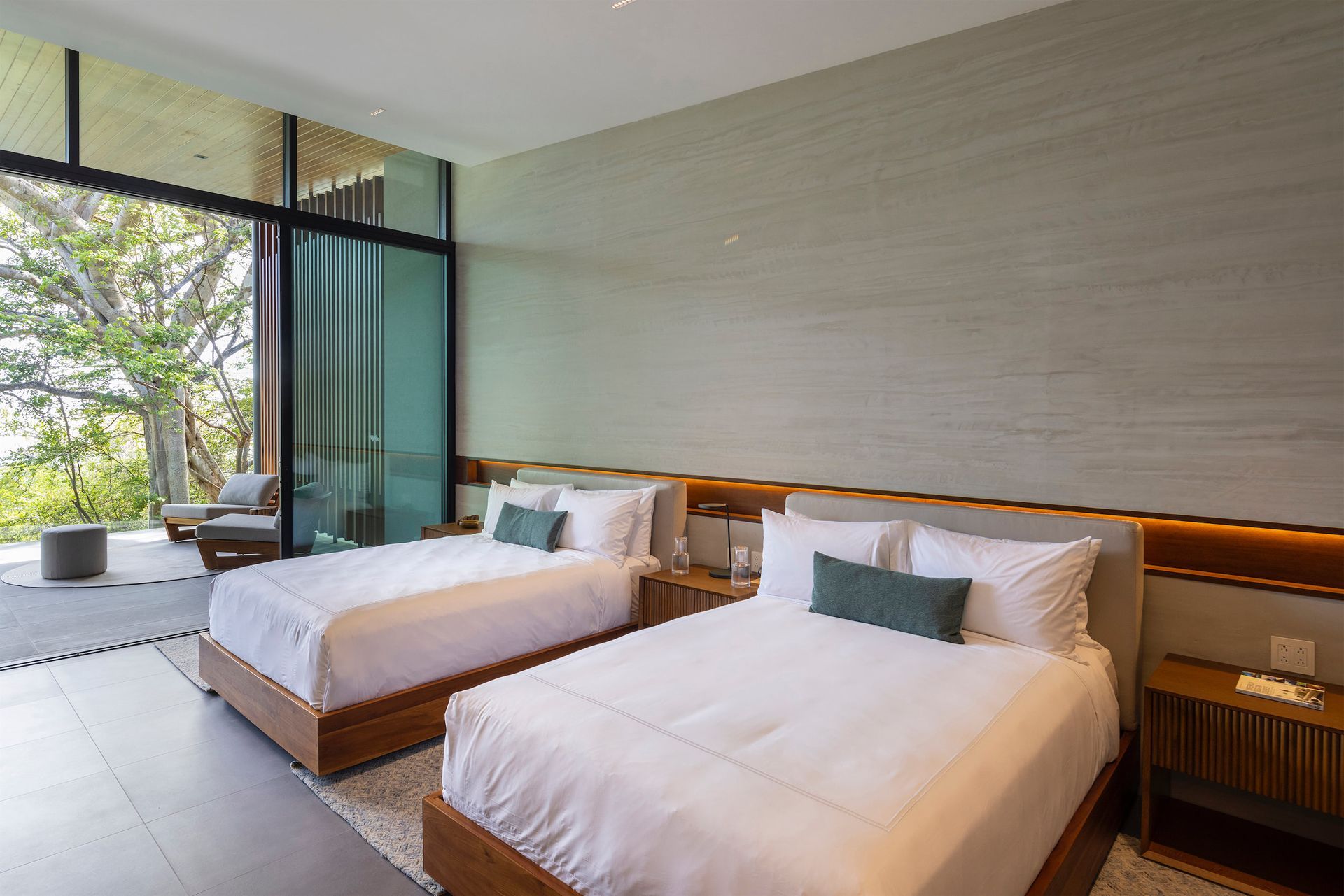 a hotel room with two beds and a large window .