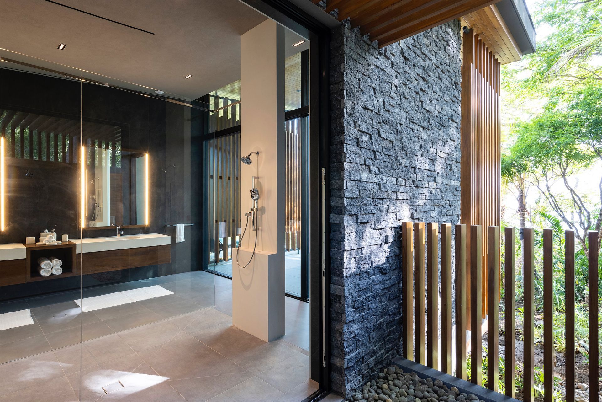 a bathroom with a sliding glass door and a wooden fence