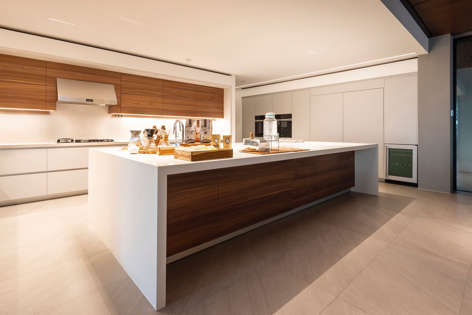 a kitchen with a large island and white cabinets