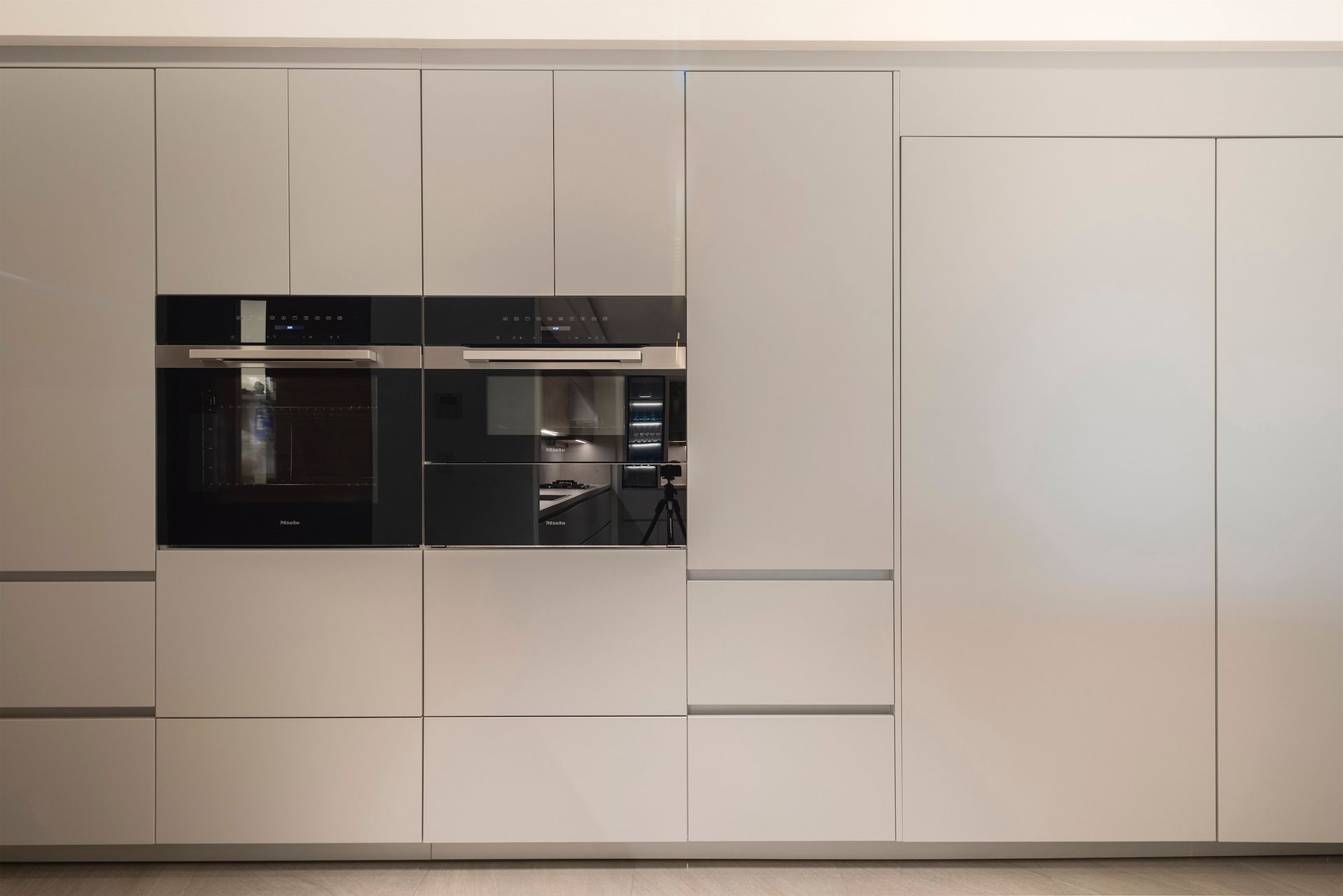 a kitchen with a refrigerator , oven , and microwave .