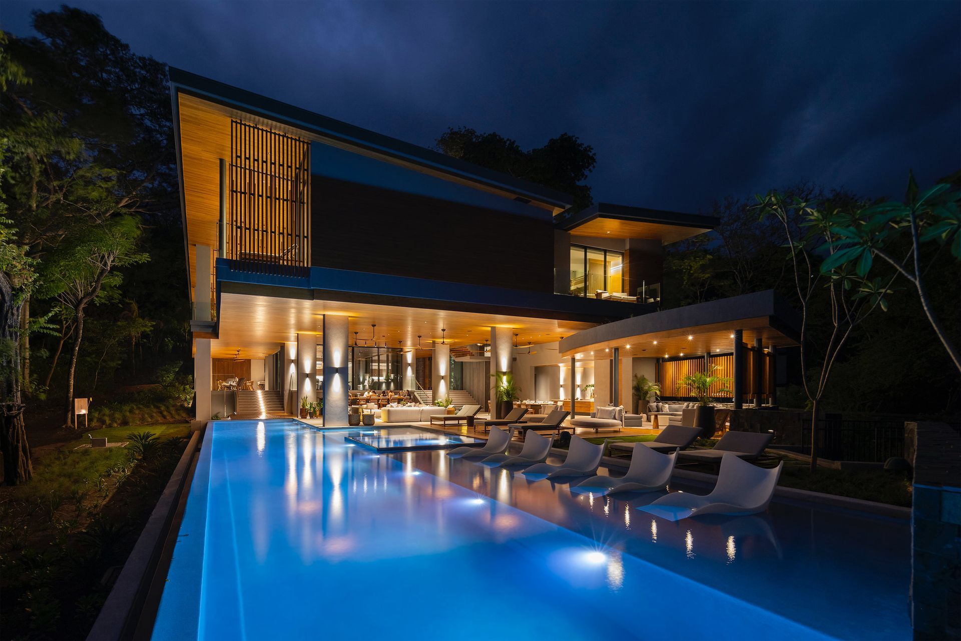 a large house with a swimming pool in front of it