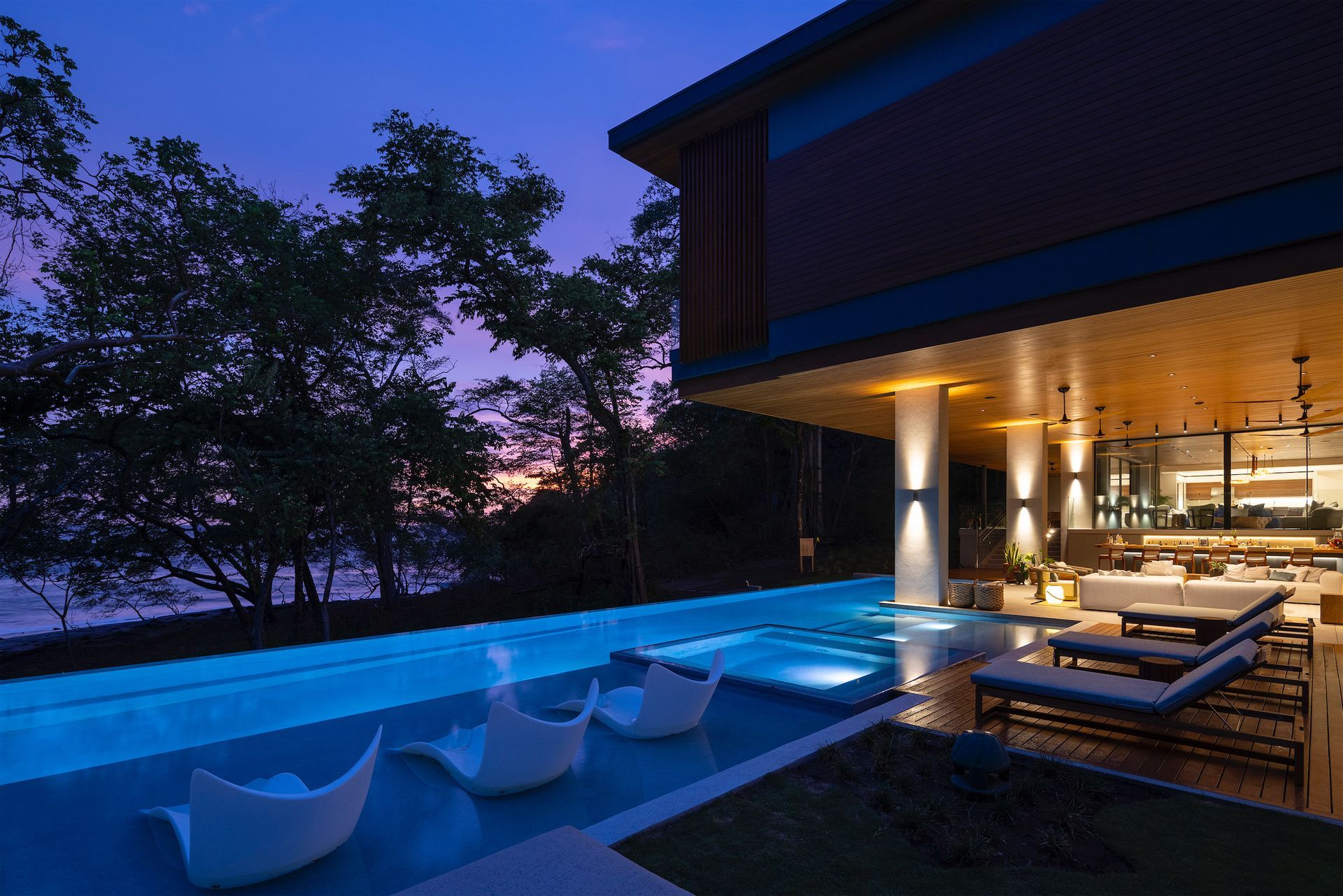 a large house with a swimming pool in front of it