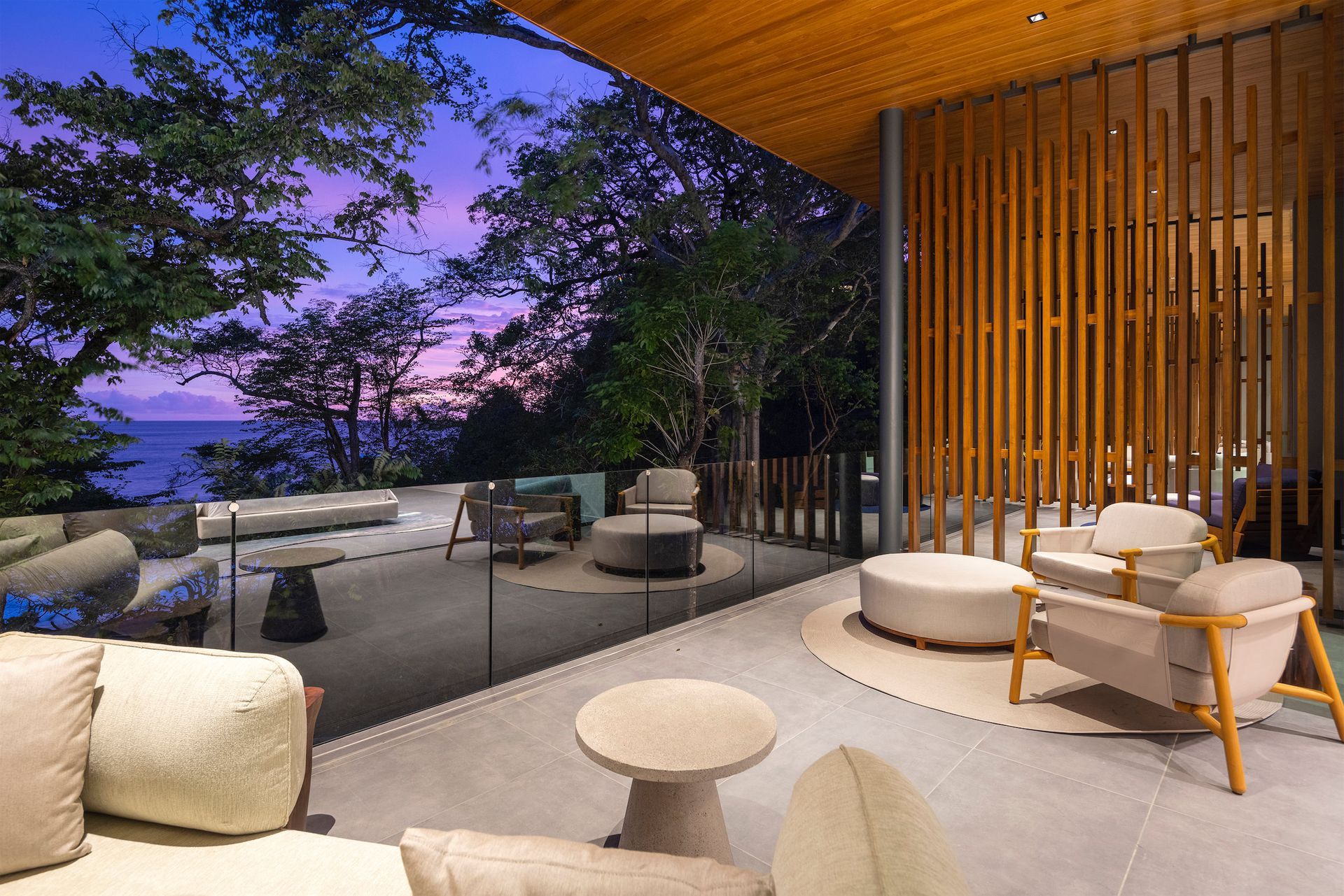 a balcony with a view of the ocean and trees