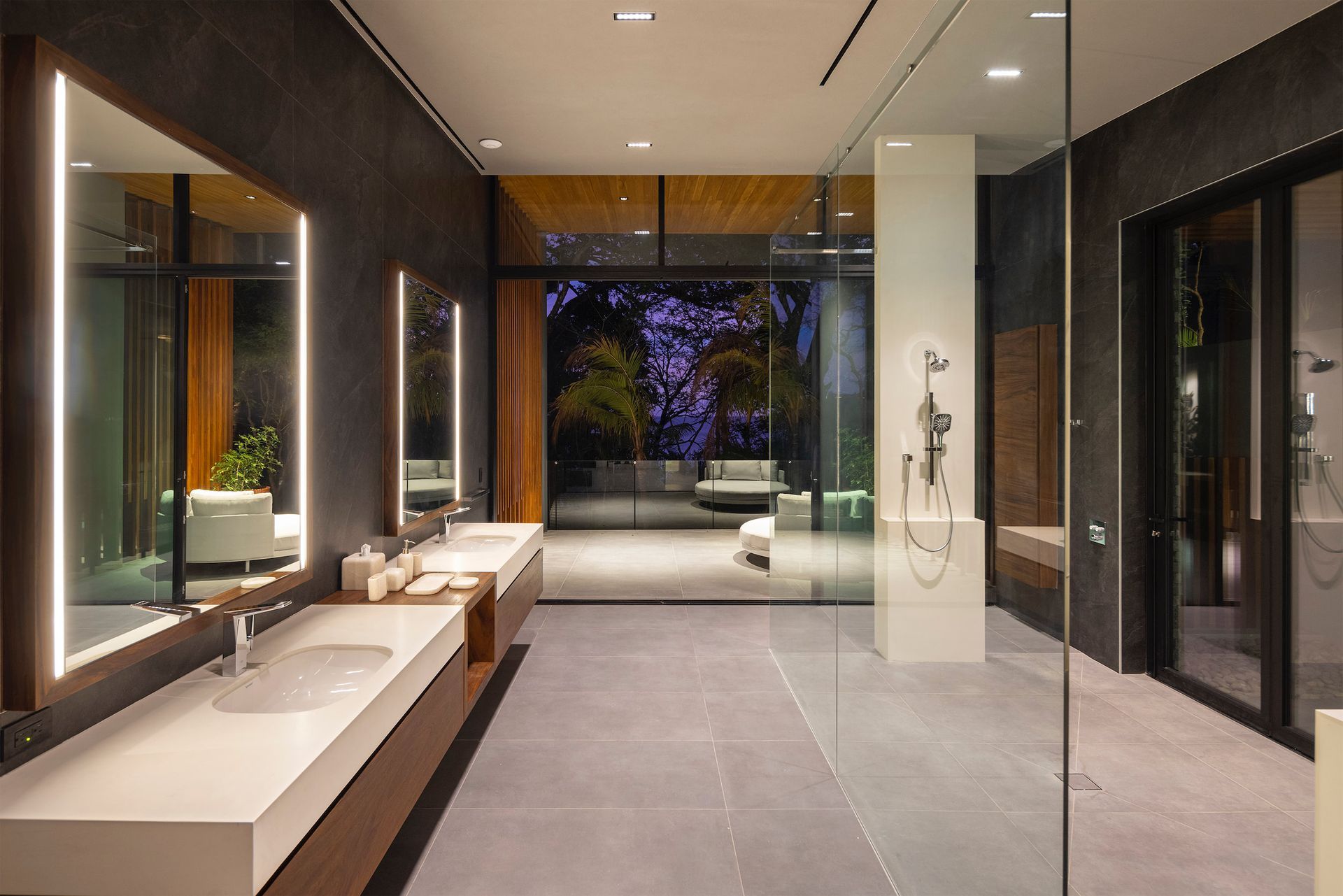 a bathroom with two sinks and a walk in shower .
