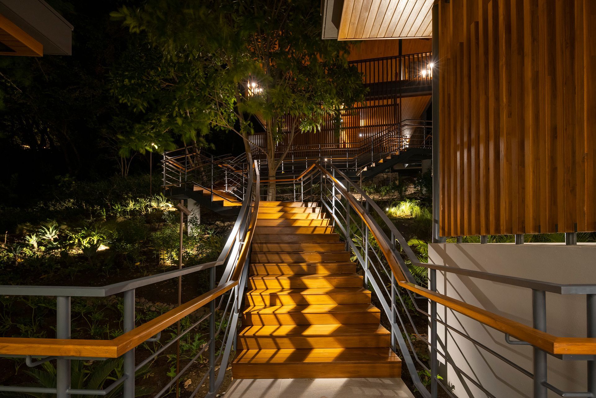 a set of stairs leading up to a building at night .
