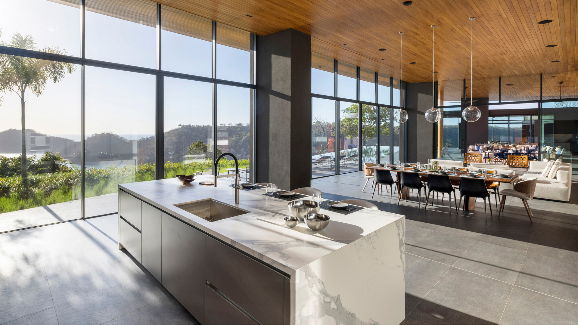A kitchen with a large island in the middle of it and a lot of windows.
