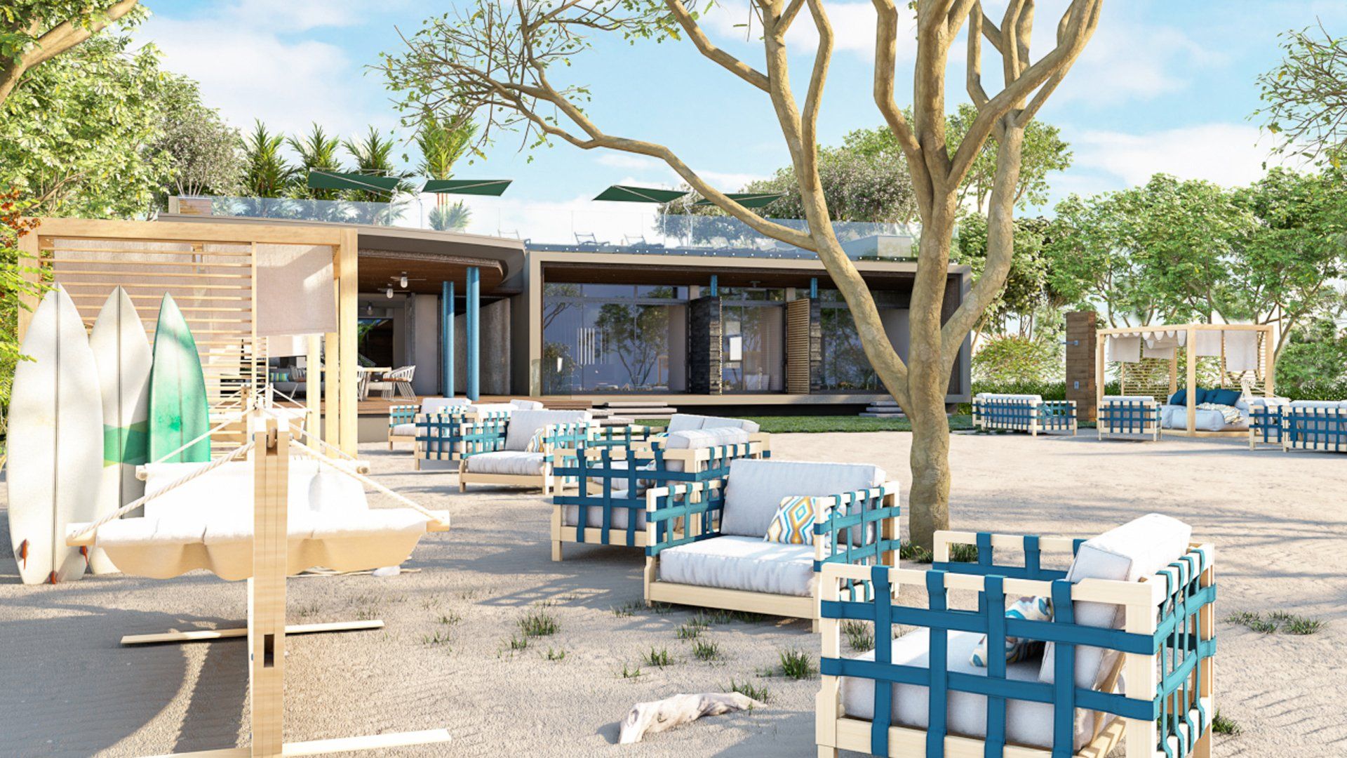 there are a lot of chairs and tables on the beach in front of a house .