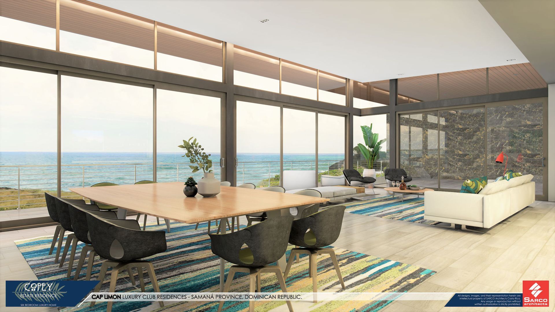 a living room with a table and chairs and a view of the ocean .