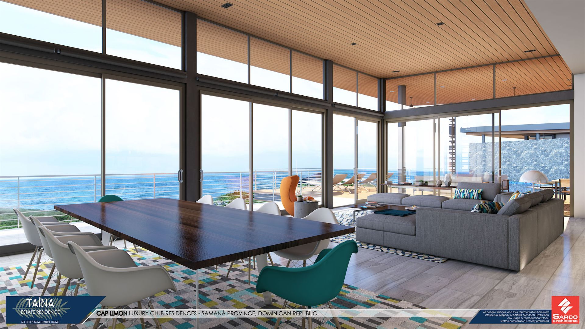 a living room with a large table and chairs and a view of the ocean .