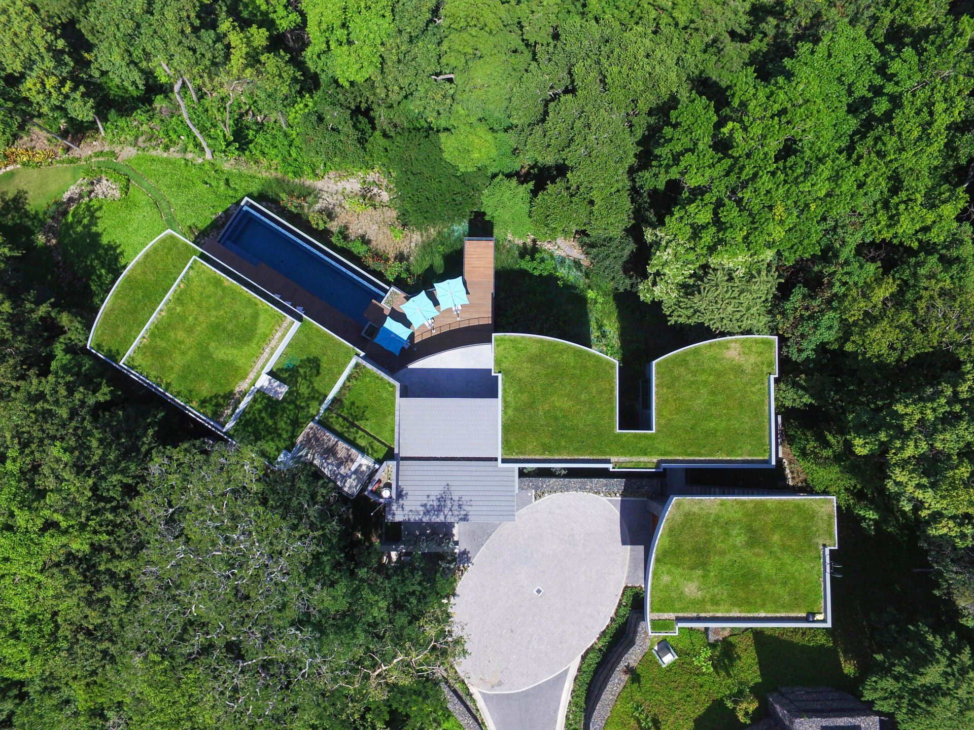 an aerial view of a house with a green roof