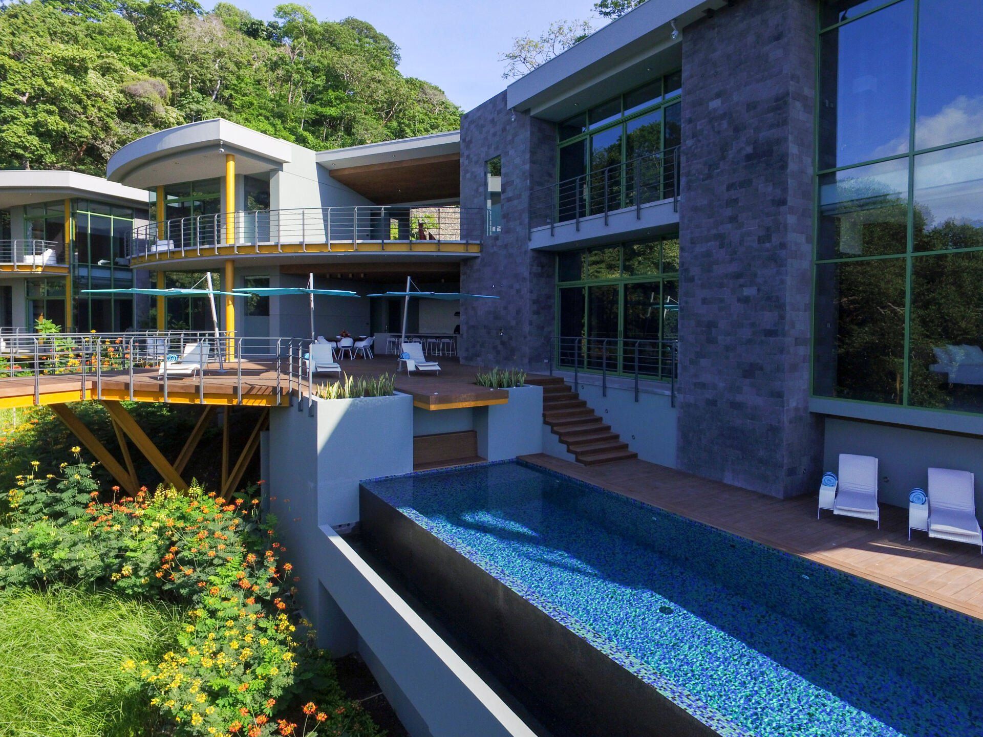 a large house with a swimming pool in front of it