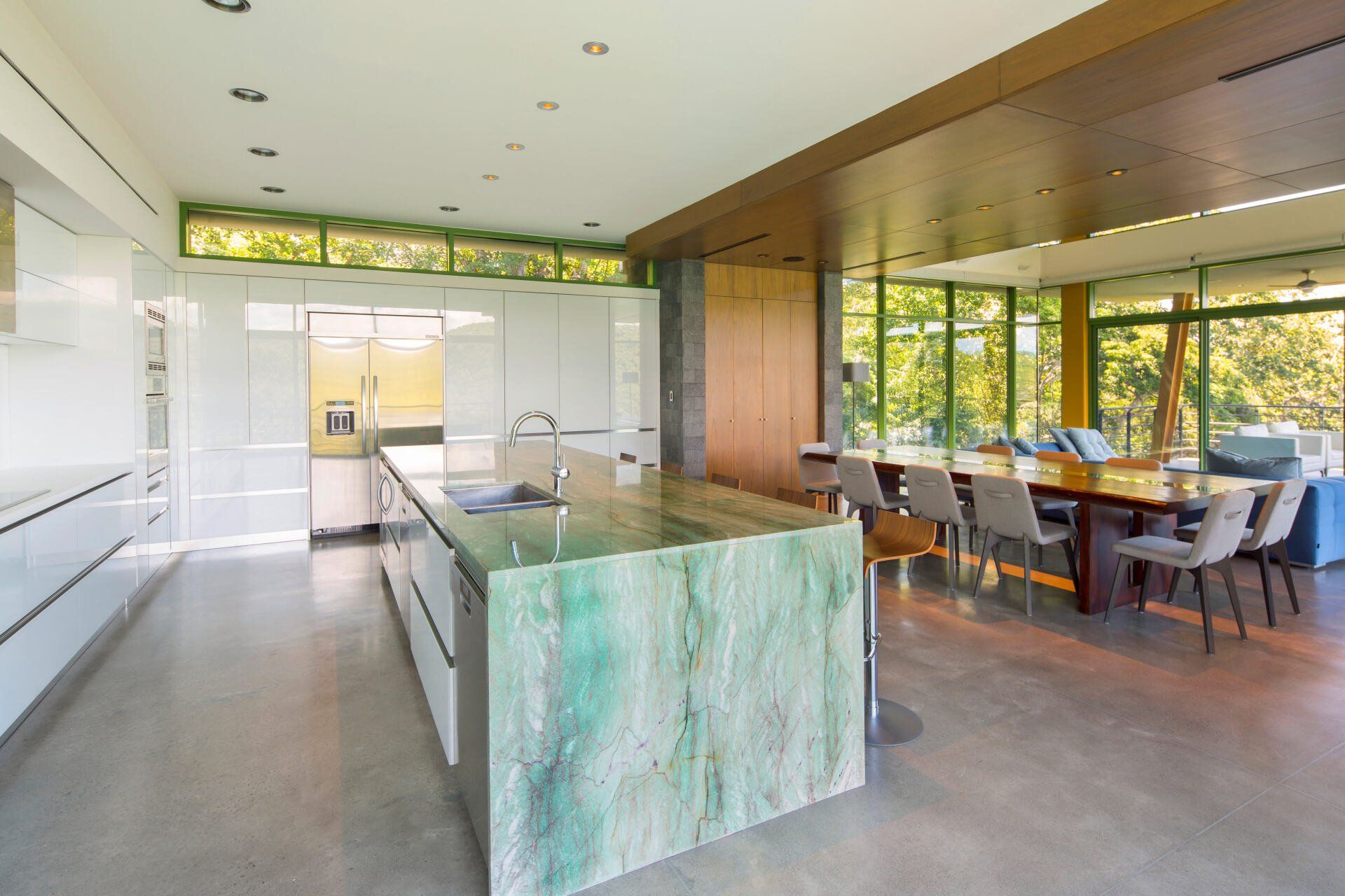 a kitchen with a large island and a dining table