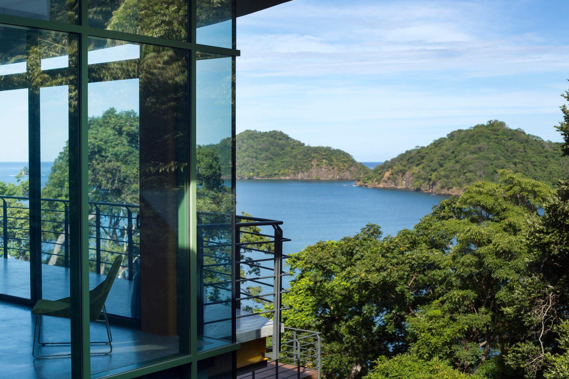 a room with a view of the ocean and mountains