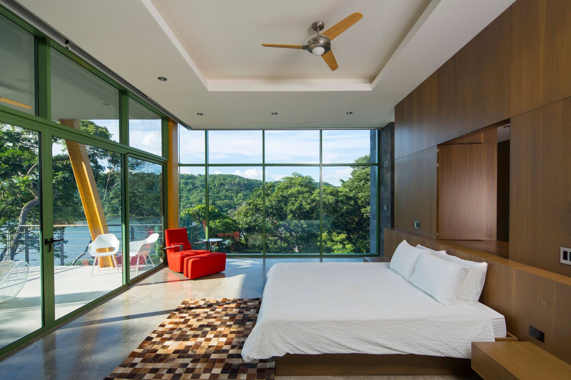 a bedroom with a large bed and a ceiling fan