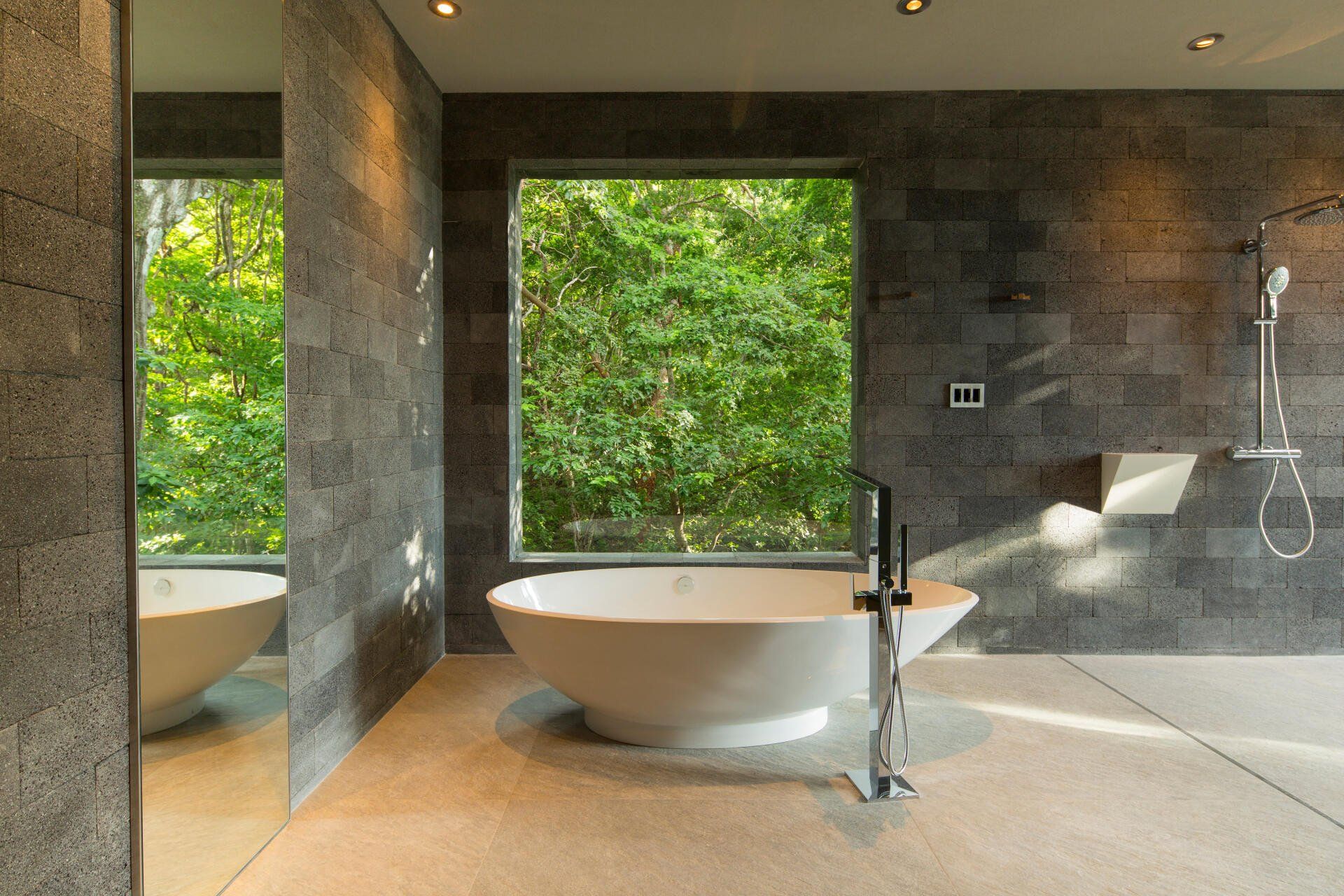 a bathroom with a large tub and a large window