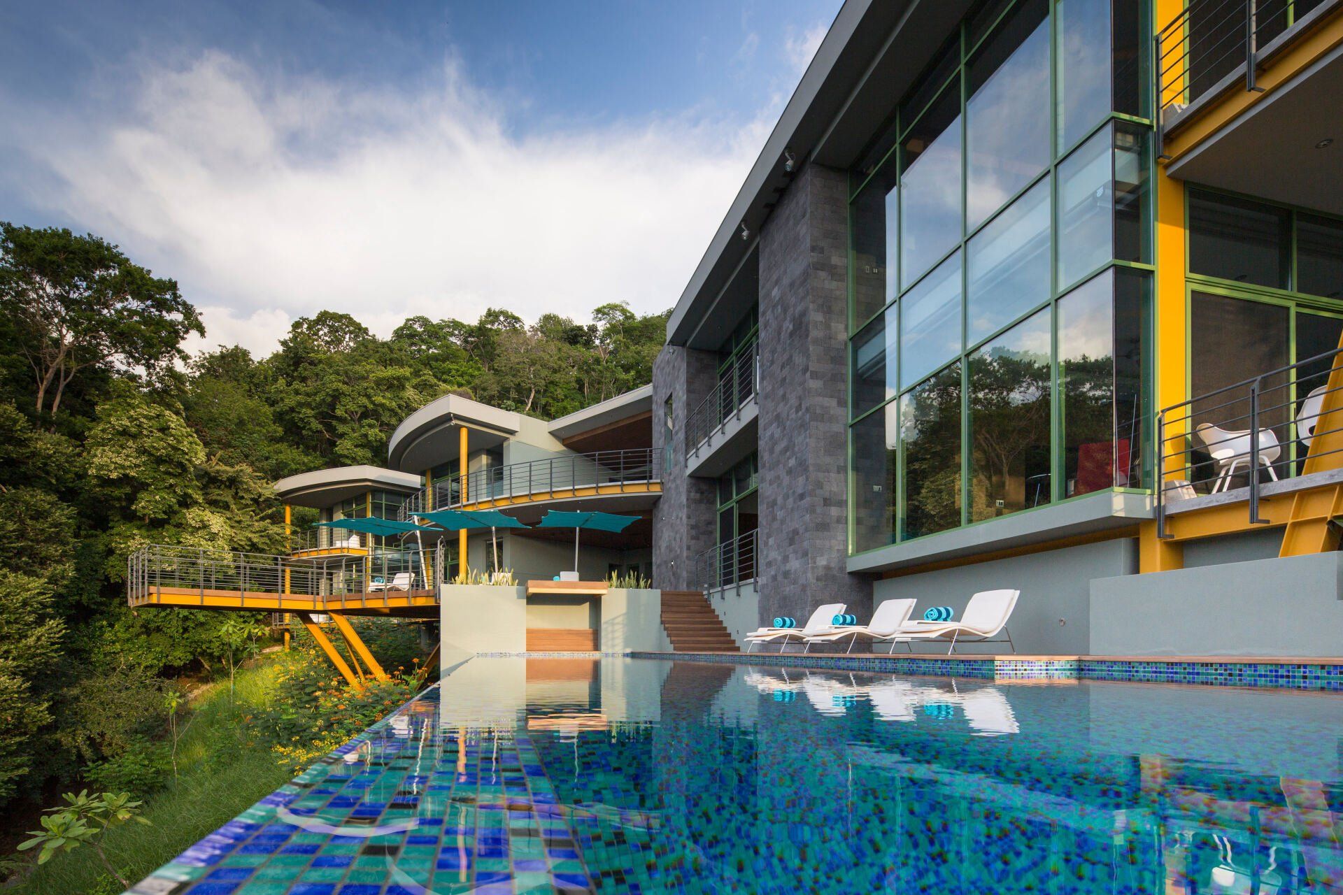 a large house with a swimming pool in front of it