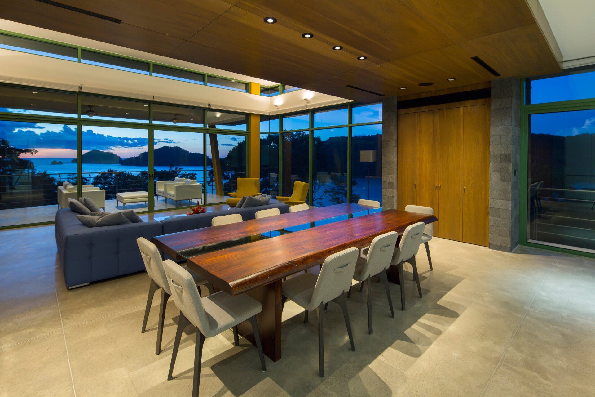 a living room with a long wooden table and chairs