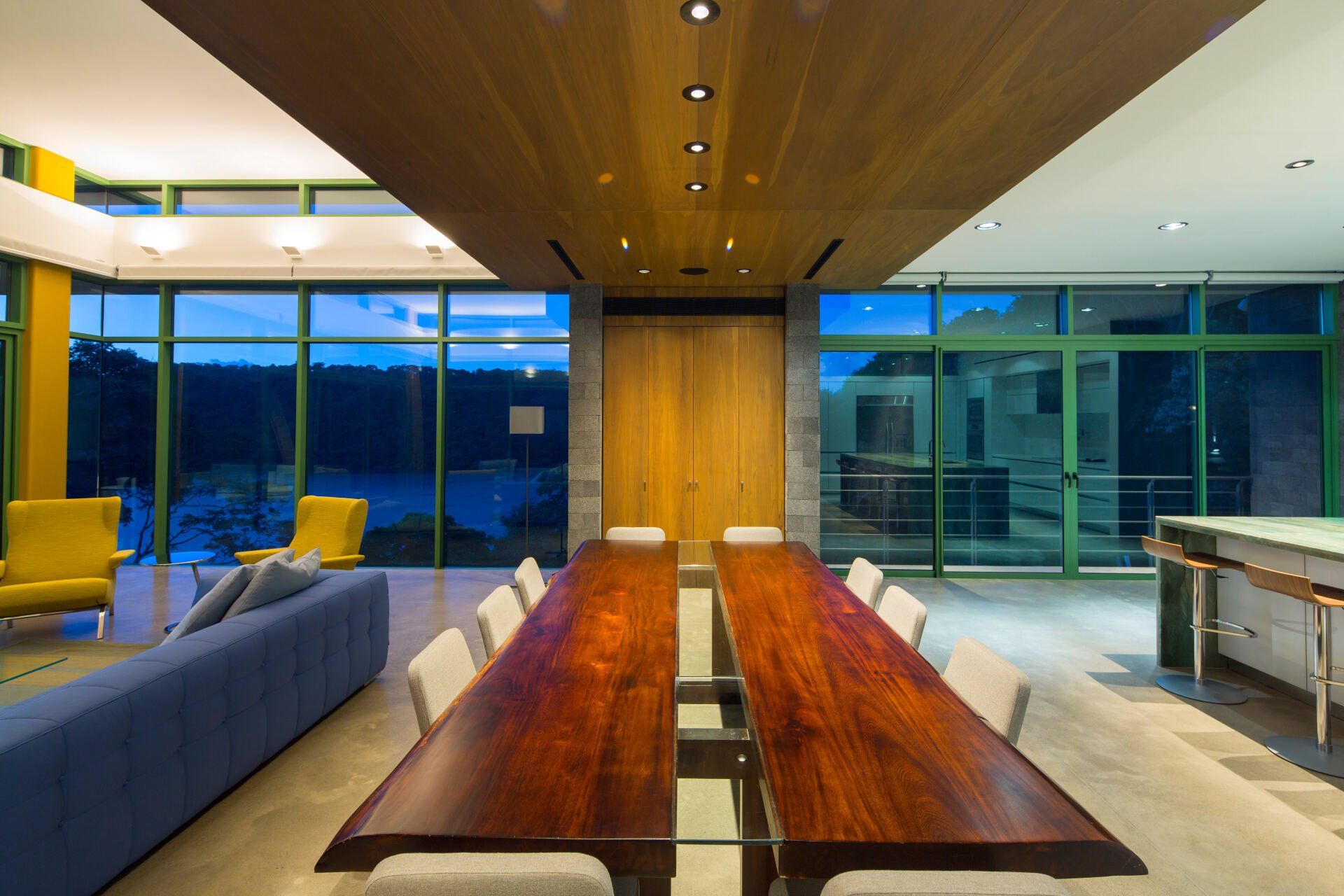 a living room with a long wooden table and chairs