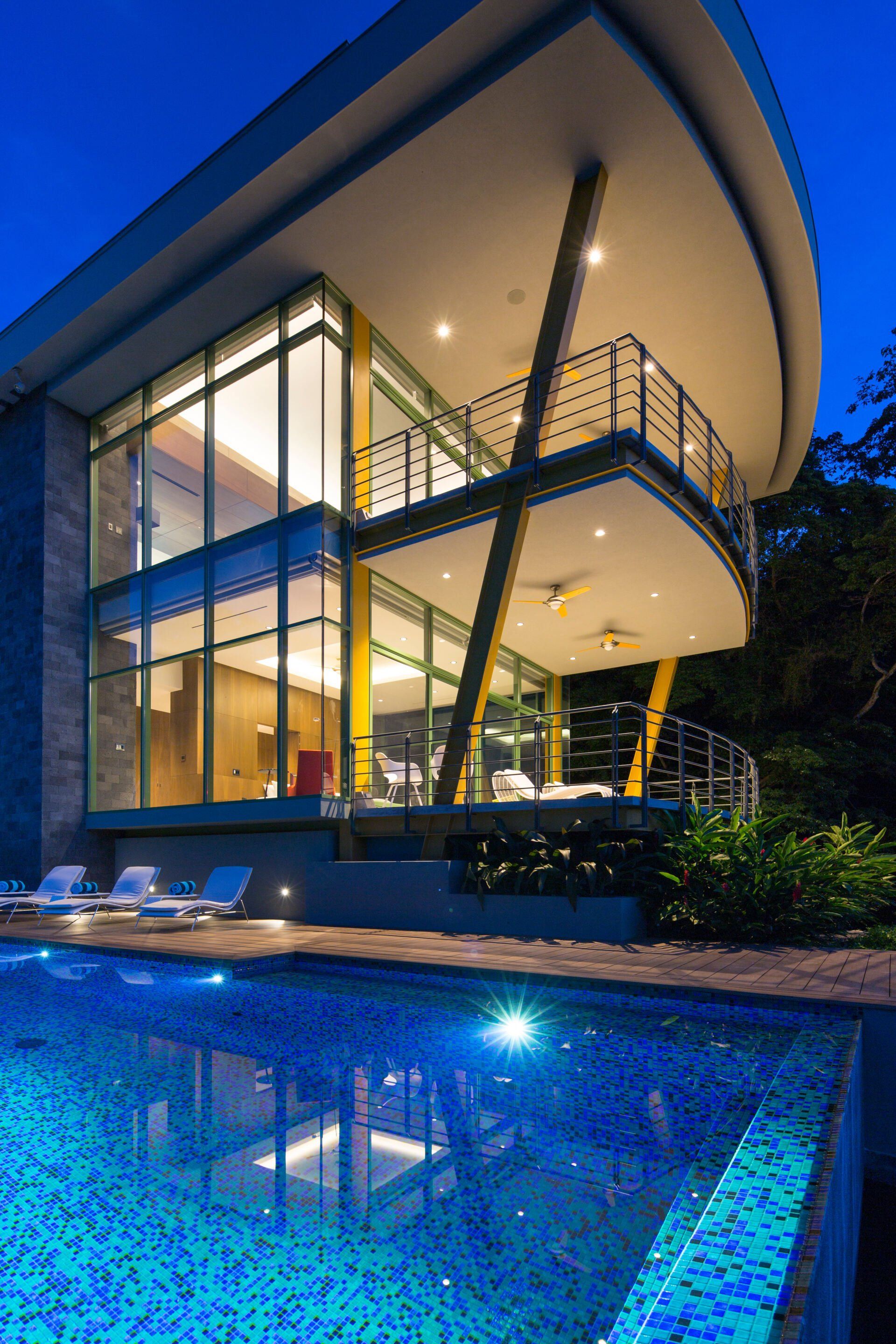 a large house with a swimming pool in front of it