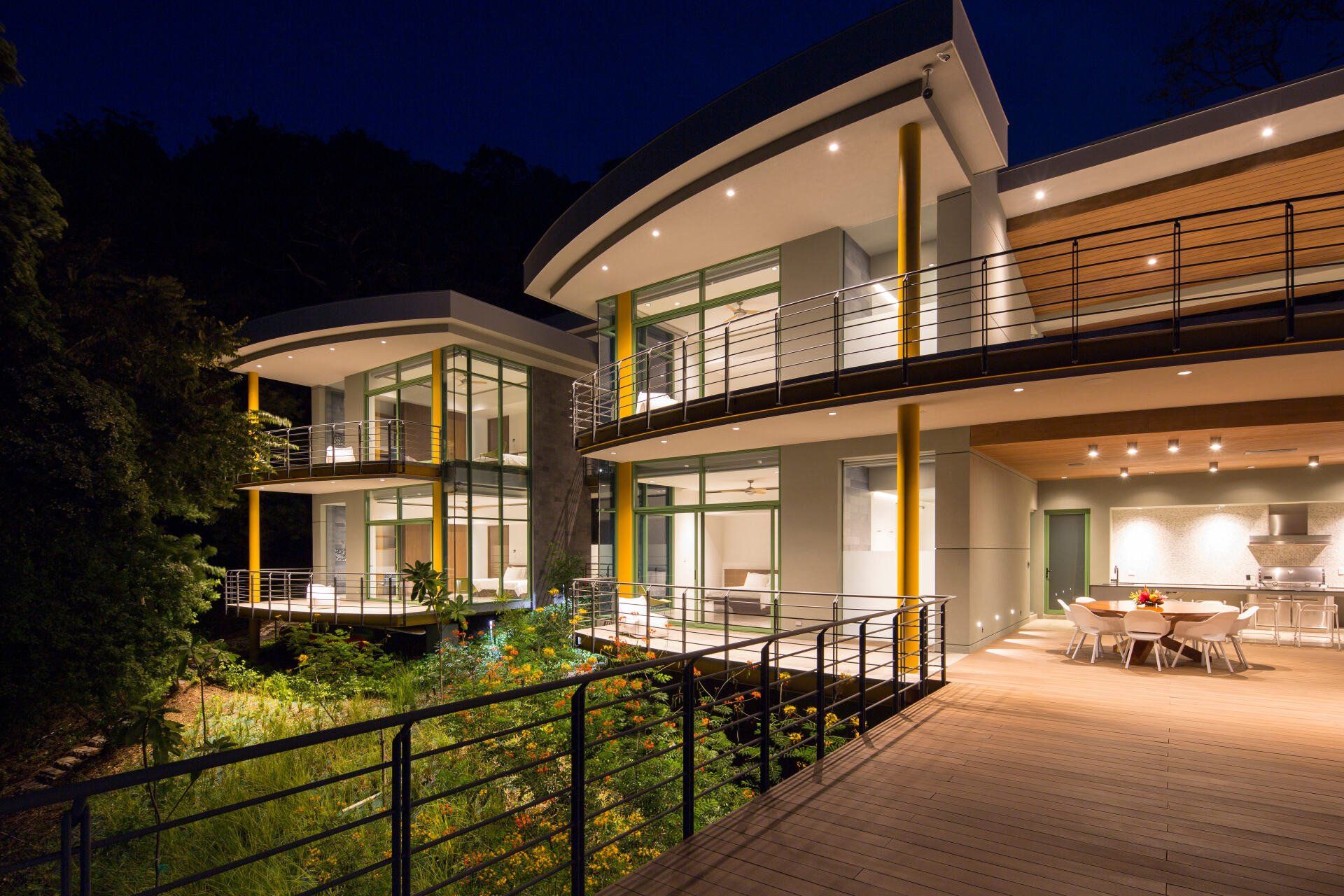 a large house with a lot of windows is lit up at night