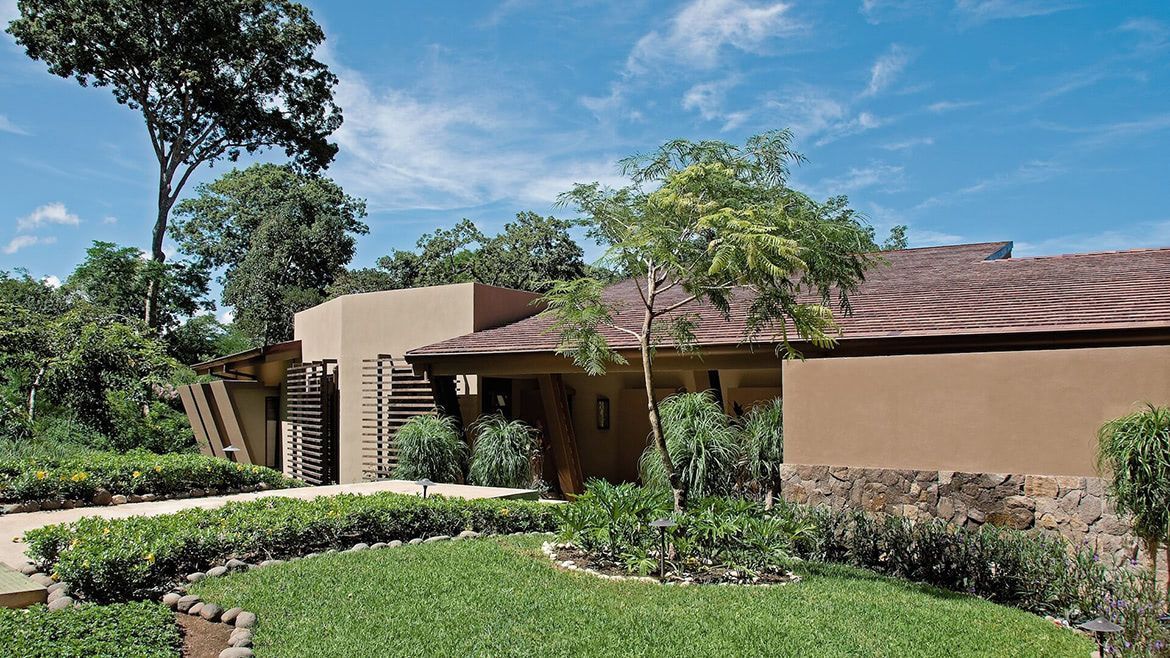 a house with a lush green lawn in front of it