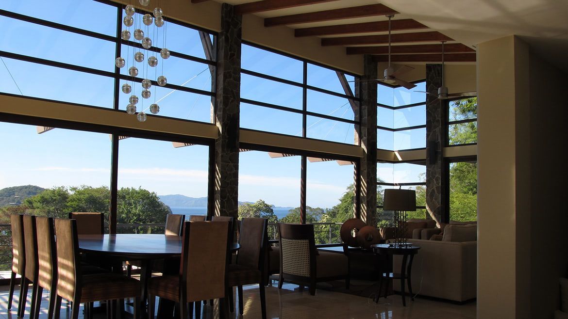 a dining room with a table and chairs in front of a large window