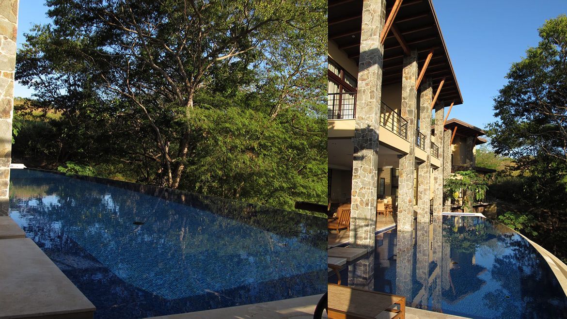 a large house with a swimming pool in front of it