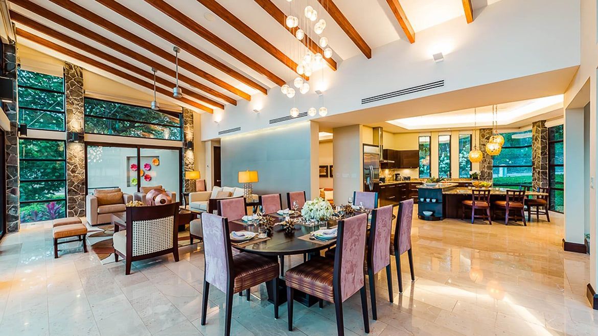 there is a dining table and chairs in the middle of the room .