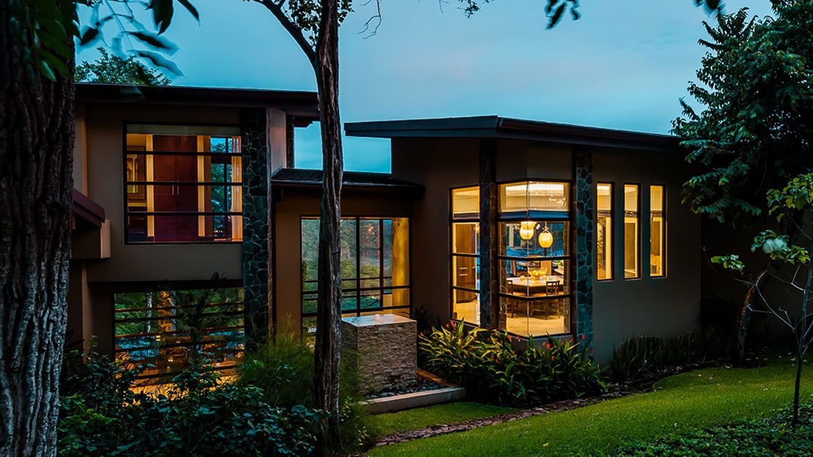 a large house with a lot of windows is lit up at night .