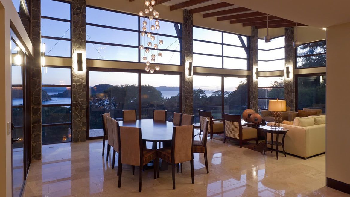 a large living room with a dining table and chairs